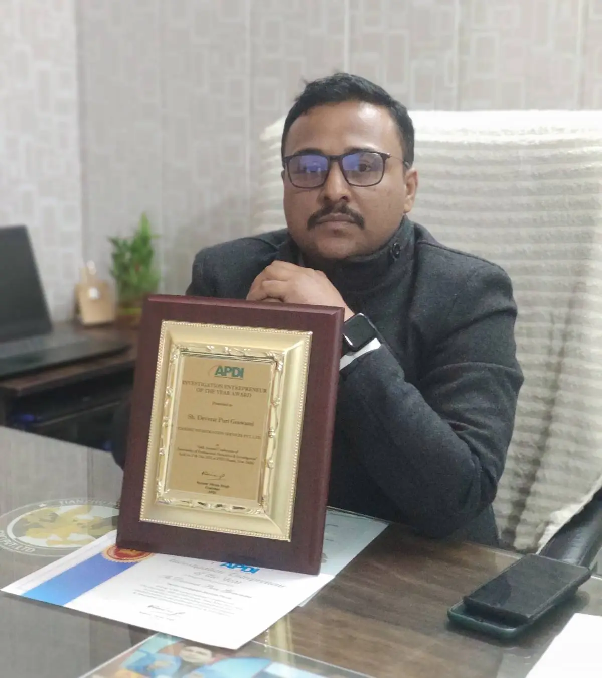 Uttarakhand Detective Services agency owner with award at office.